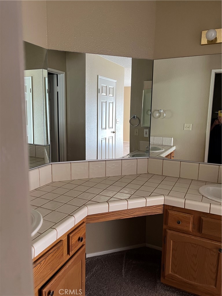 11687 Maple Street Apple Valley, CA 92308 - Photo 7 of 15 a view of cabinets a sink and dishwasher in a kitchen