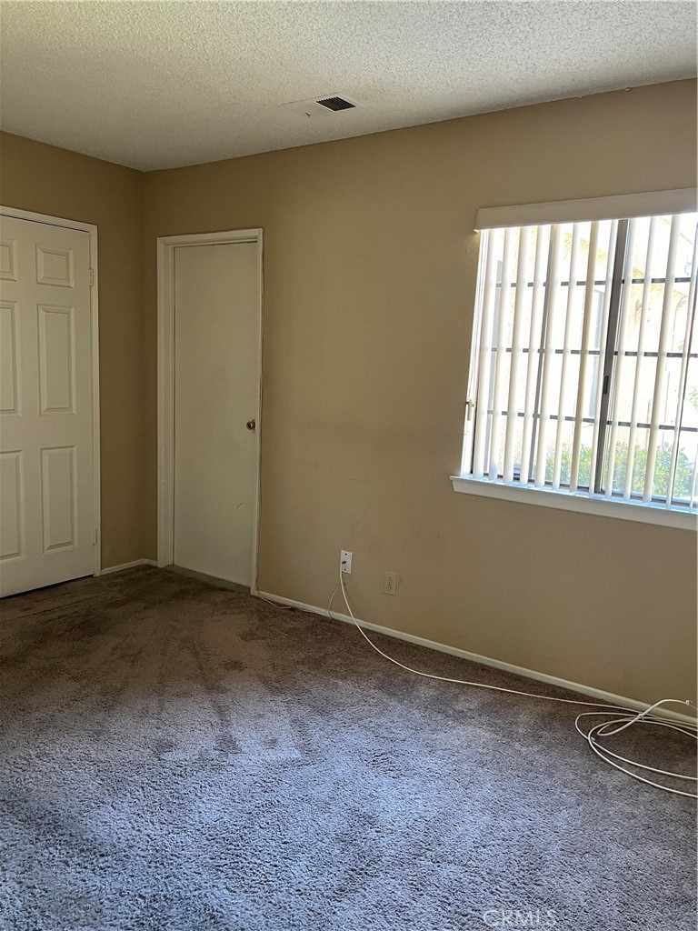 11687 Maple Street Apple Valley, CA 92308 - Photo 8 of 15 a view of an empty room with a window