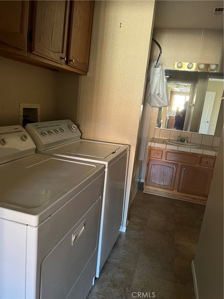 11687 Maple Street Apple Valley, CA 92308 - Photo 9 of 15 a utility room with dryer and washer