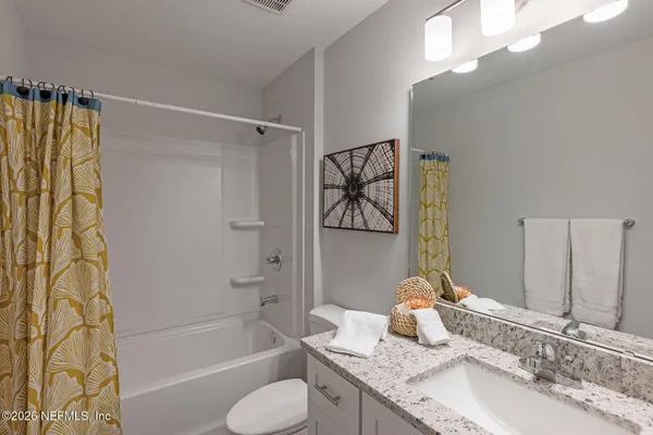 a bedroom with a bed and a ceiling fan