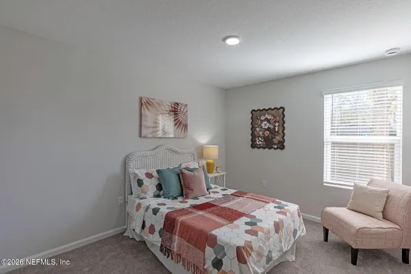 a bedroom with a bed and a ceiling fan