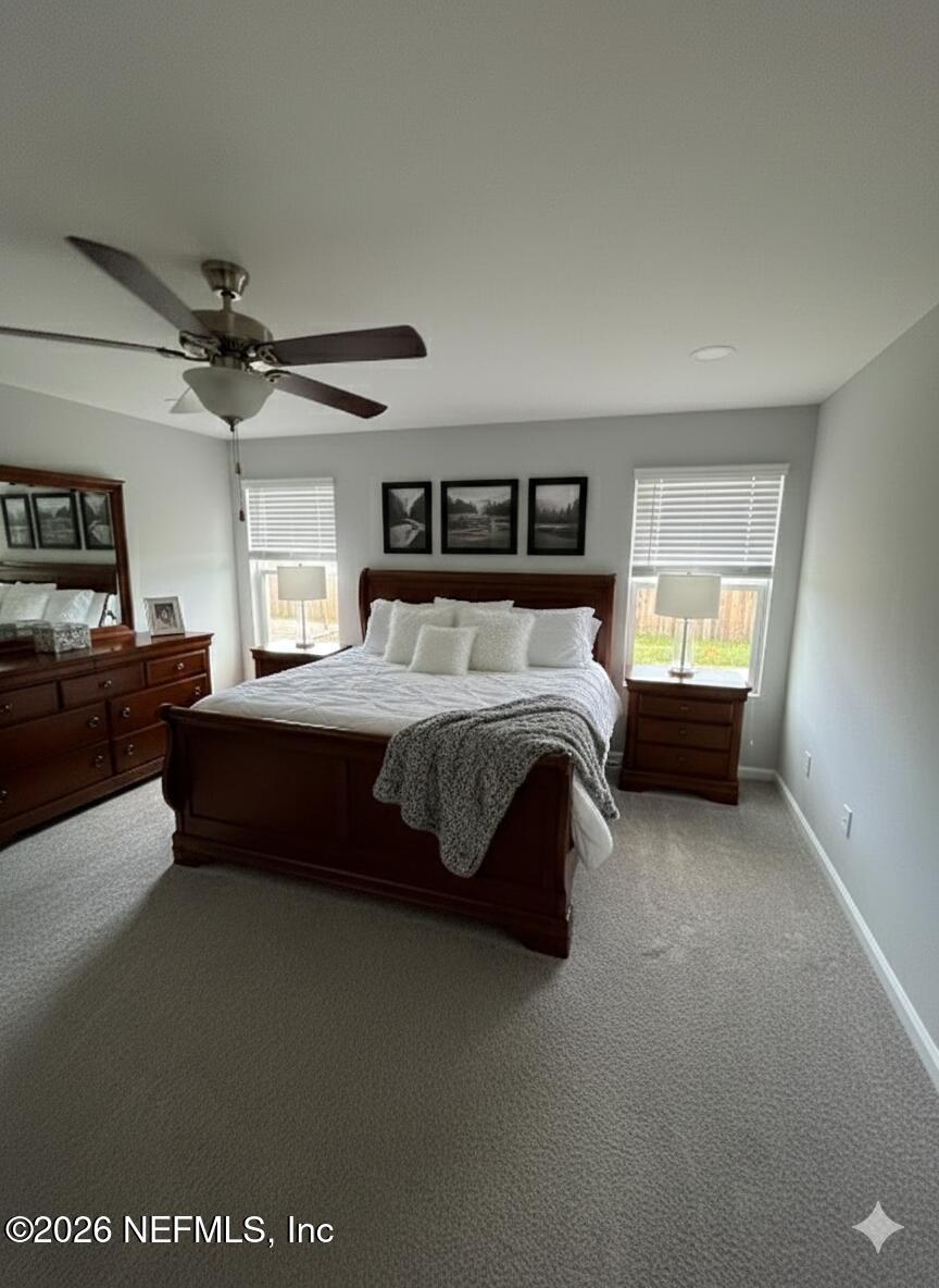 1295 Jewelstone Lane Jacksonville, FL 32221 - Photo 5 of 33 a bedroom with a bed and a ceiling fan