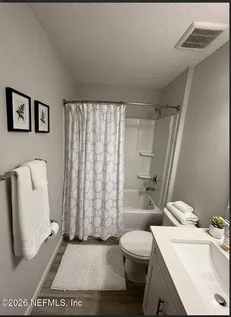 a bathroom with a shower and a toilet