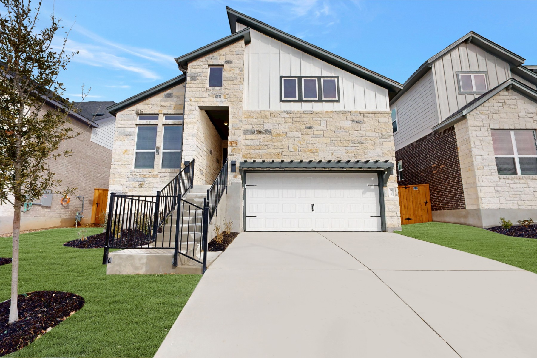 a front view of a house with a yard and garage