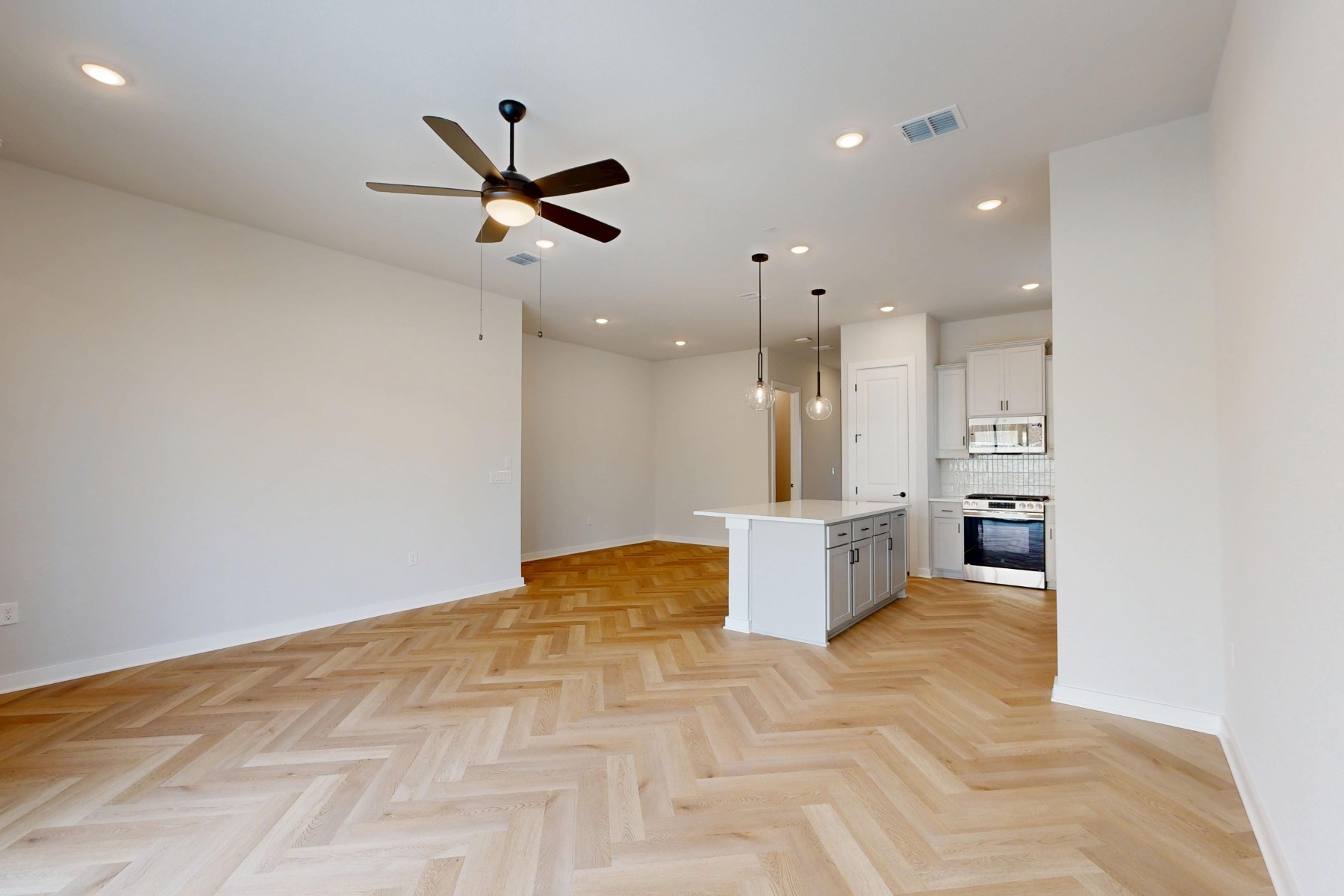 812 Boise Drive Leander, TX 78641 - Photo 5 of 35 a view of a kitchen with kitchen island a counter top space appliances and a ceiling fan