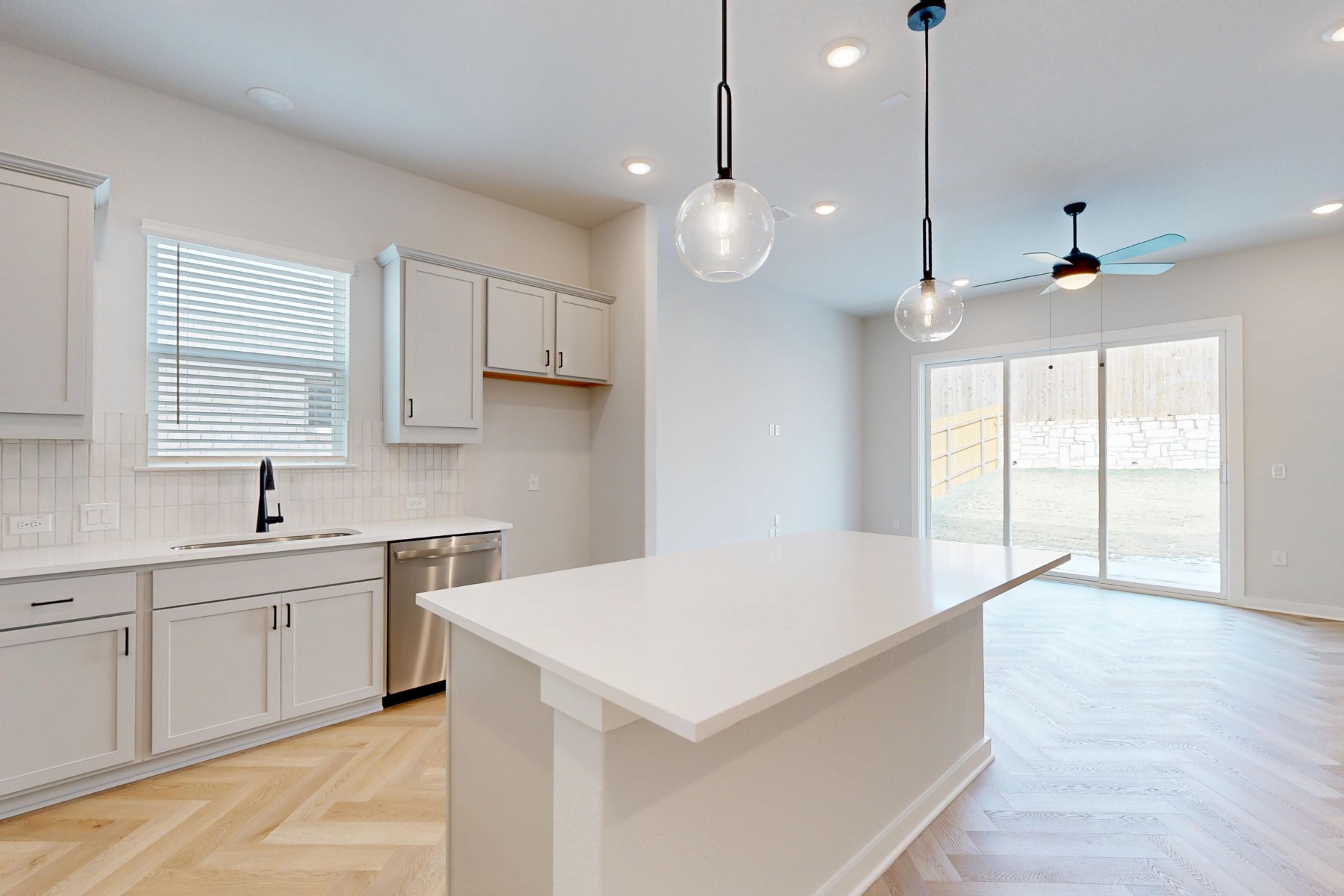 812 Boise Drive Leander, TX 78641 - Photo 8 of 35 a large white kitchen with a large window a sink and cabinets