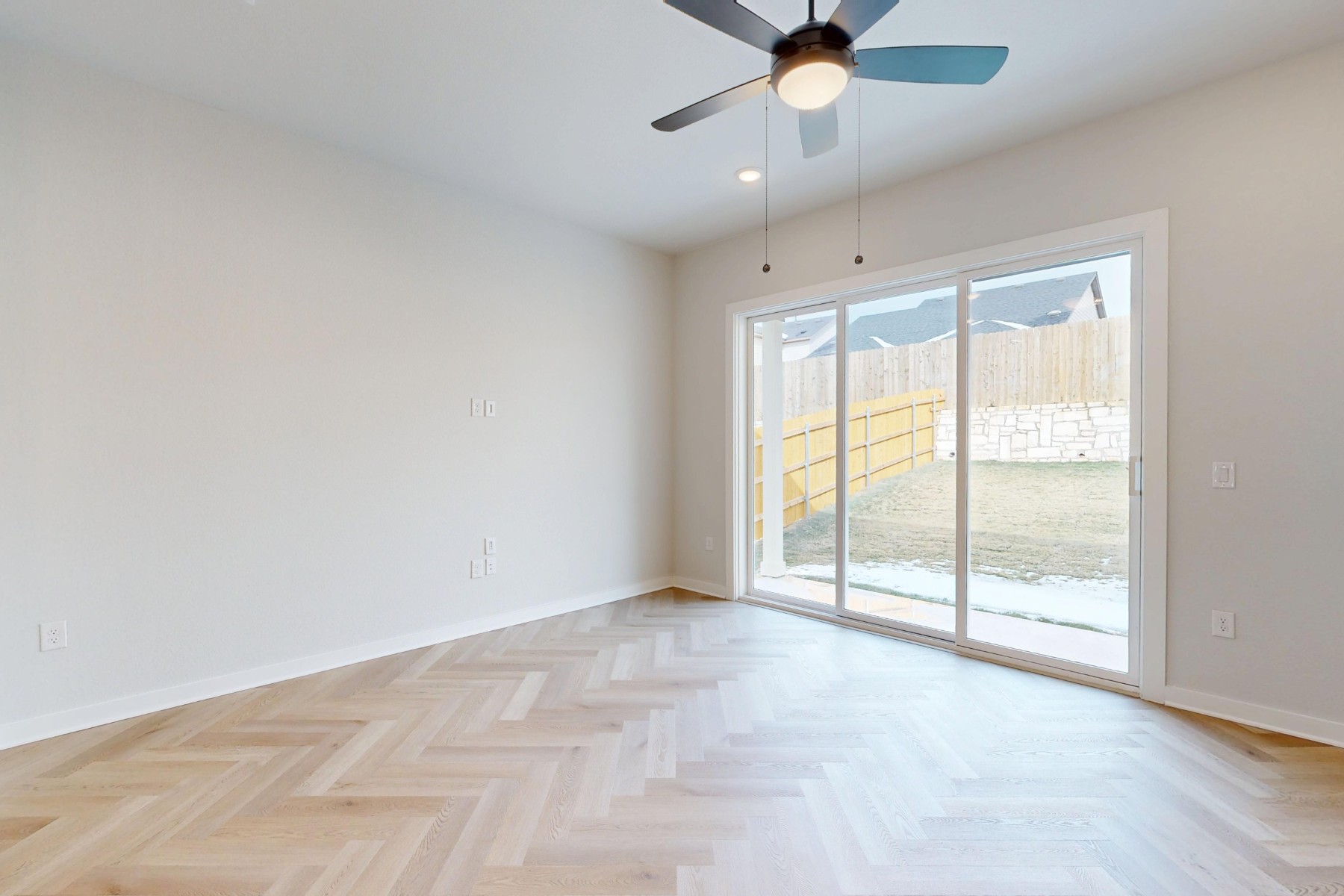 812 Boise Drive Leander, TX 78641 - Photo 10 of 35 an empty room with chandelier fan and windows