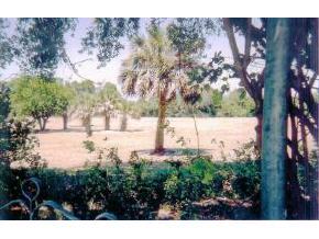 913 Northeast Darwin Palm Bay, FL 32905 - Photo 2 of 3 a view of a yard with wooden fence