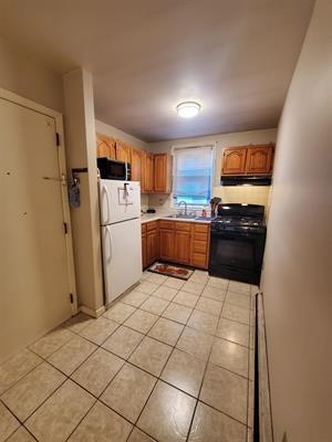 18 Mechanic Street Bayonne, NJ 07002 - Photo 1 of 8 a kitchen with a refrigerator a stove top oven and a sink