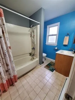 a spacious bedroom with a bed and a couch