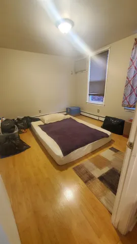 a bedroom with a bed and a window