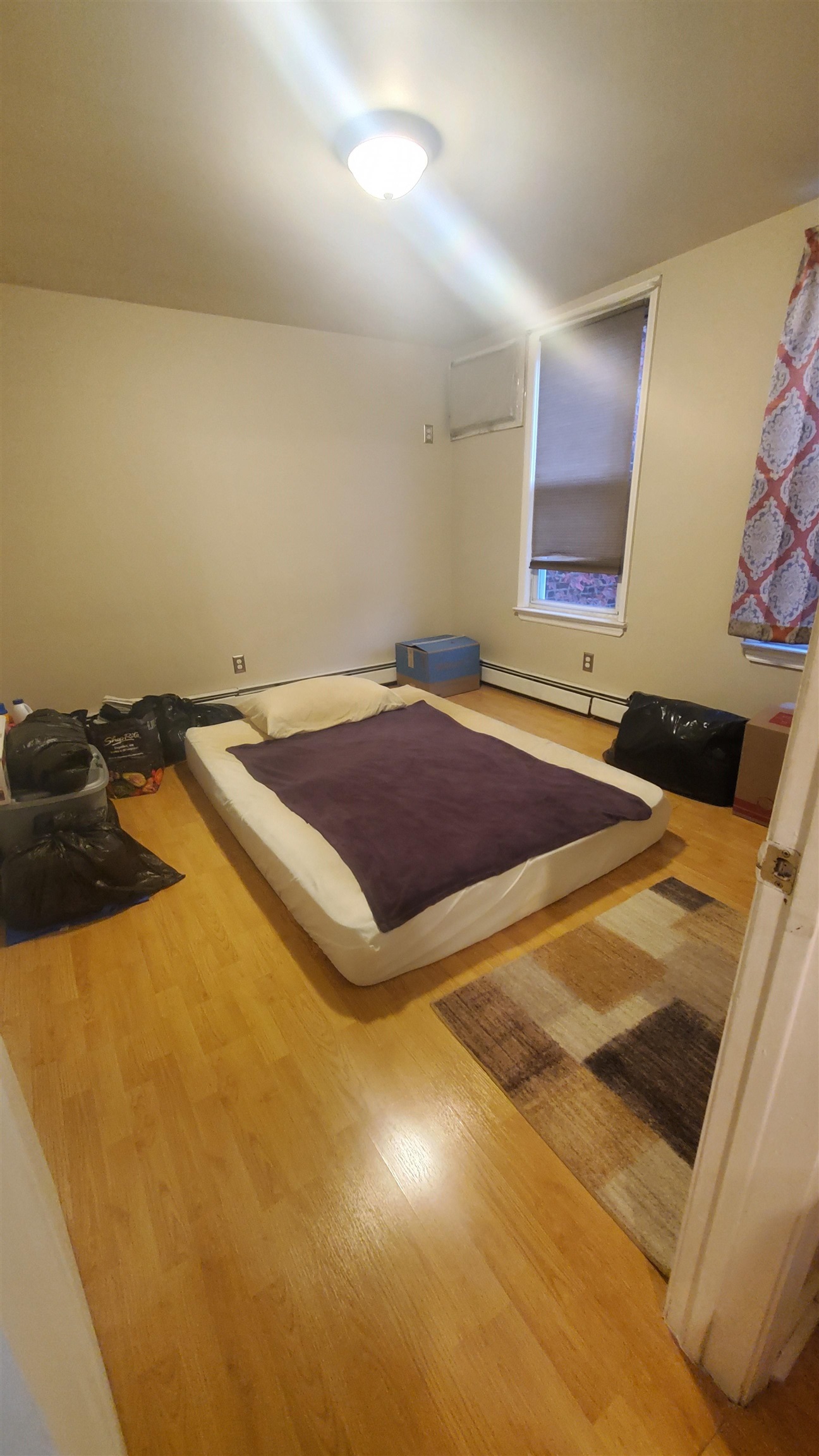 18 Mechanic Street Bayonne, NJ 07002 - Photo 4 of 8 a bedroom with a bed and a window