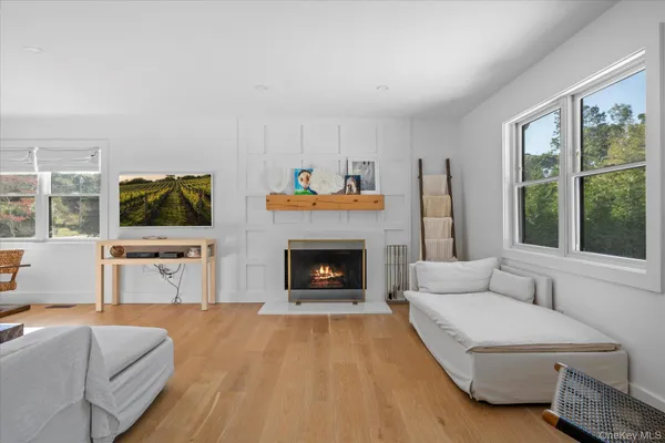 a living room with furniture a fireplace and a flat screen tv