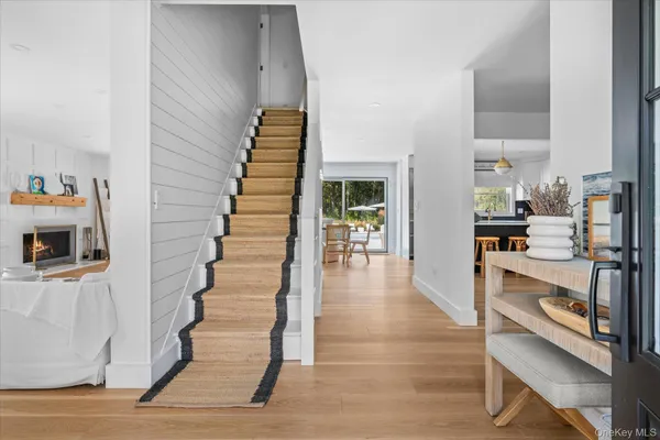 a view of entryway and hall with wooden floor
