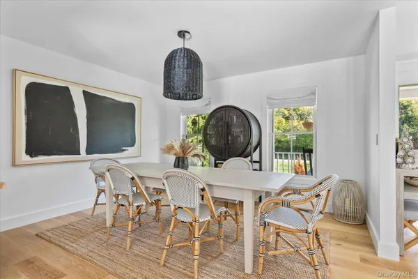 a view of a dining room with furniture and chandelier