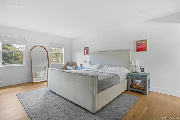 a bed sitting in a bedroom next to a window