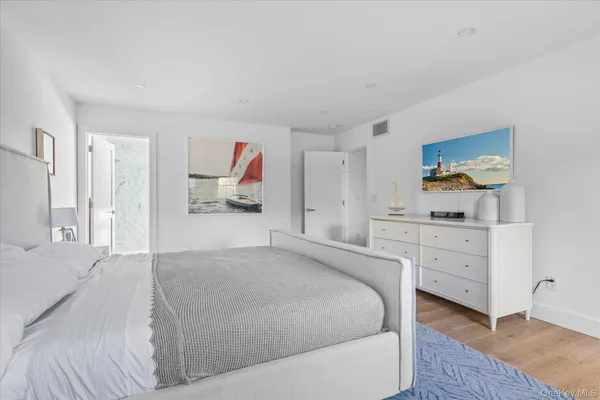 a bedroom with a bed and a dresser