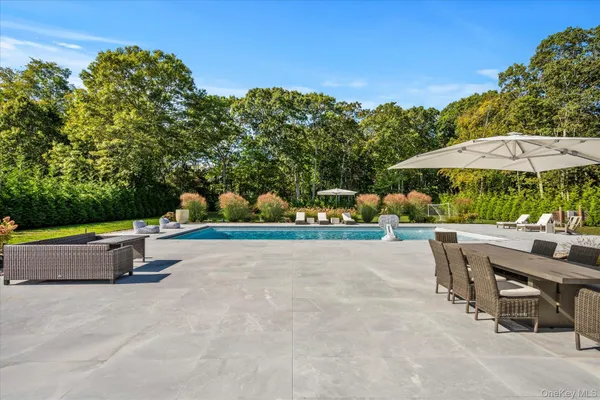 a view of backyard with outdoor seating and trees