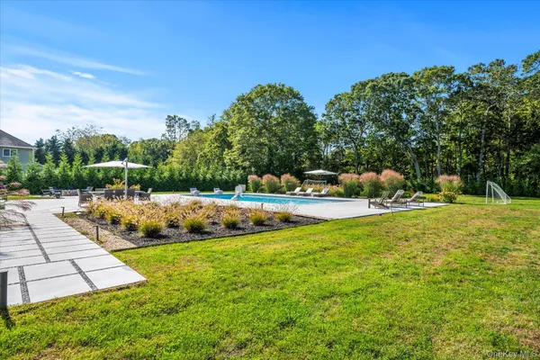 a view of yard with swimming pool and green space