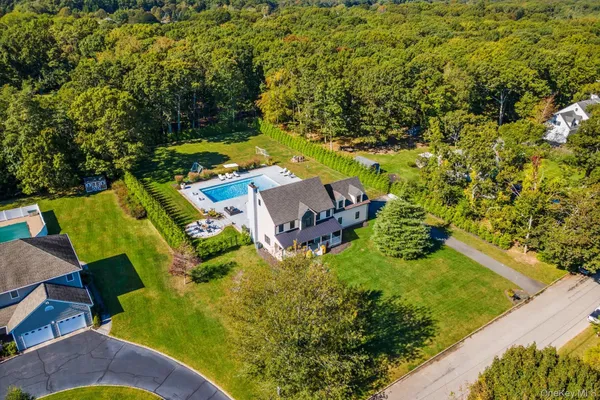 an aerial view of a house with a yard basket ball court and outdoor seating