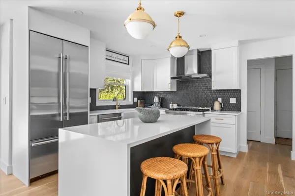 a kitchen with a dining table chairs sink and stove
