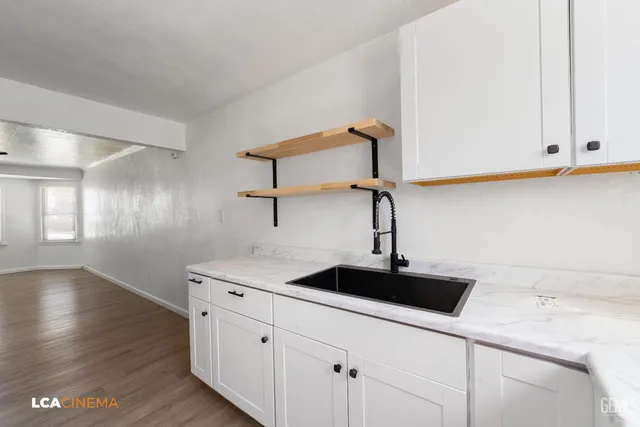 a kitchen with a sink and cabinets