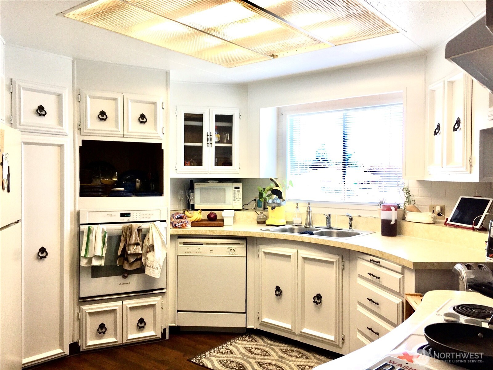 402 West 6th Avenue Ritzville, WA 99169 - Photo 2 of 19 a kitchen with a stove a sink and a refrigerator with white cabinets