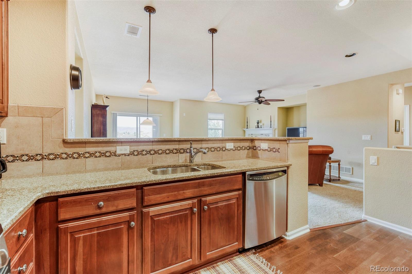 3355 Cascina Circle, Unit B Highlands Ranch, CO 80126 - Photo 13 of 28 a kitchen with a sink and cabinets