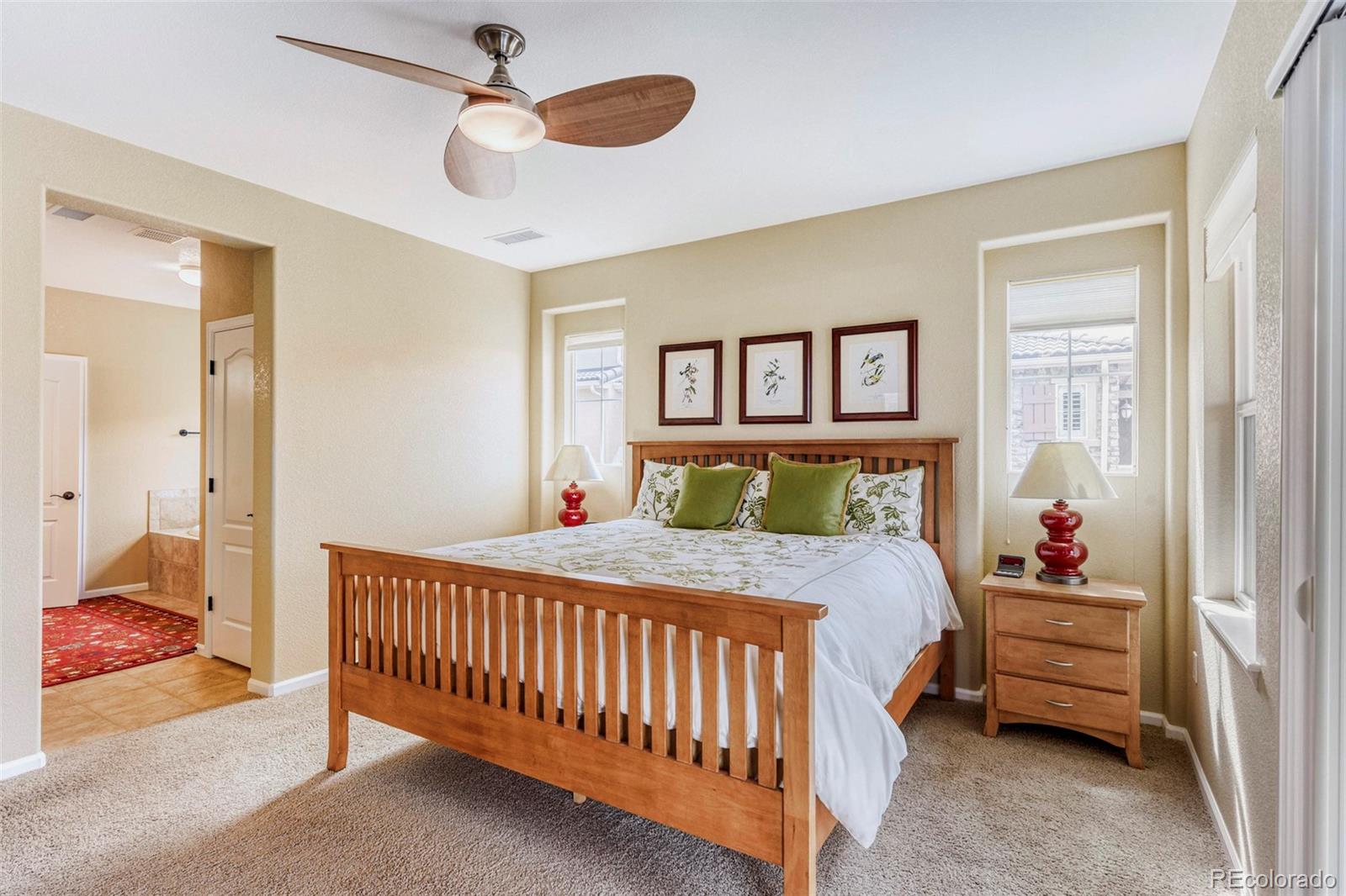 3355 Cascina Circle, Unit B Highlands Ranch, CO 80126 - Photo 17 of 28 a bedroom with a bed and a chandelier