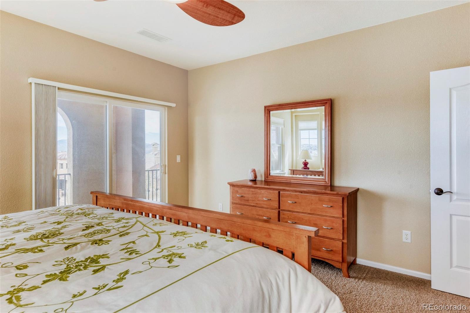 3355 Cascina Circle, Unit B Highlands Ranch, CO 80126 - Photo 18 of 28 a bedroom with a bed and a dresser