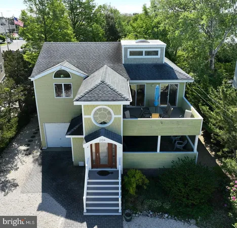 a front view of house with yard and trees in the background