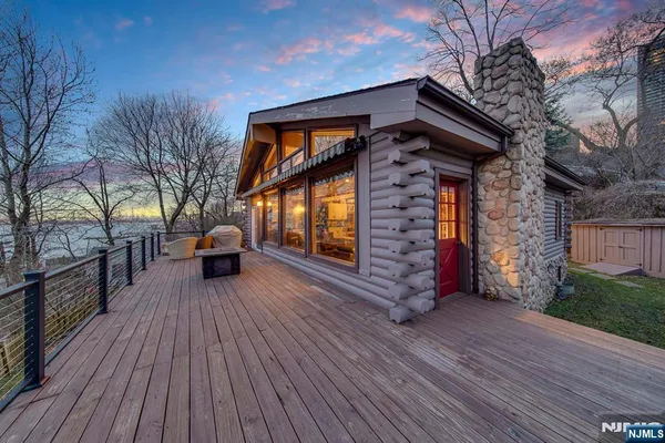 a view of a house with a barbeque grill and wooden floor
