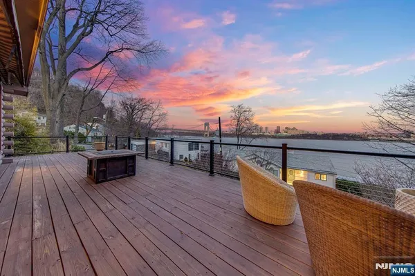 a view of roof deck with seating space and trees
