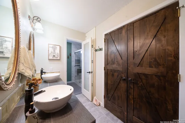 a bathroom with a toilet sink and shower curtain