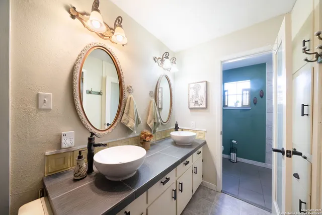 a bathroom with a toilet a sink and a mirror