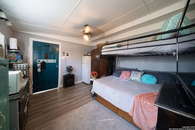 a bedroom with a bed and a mirror