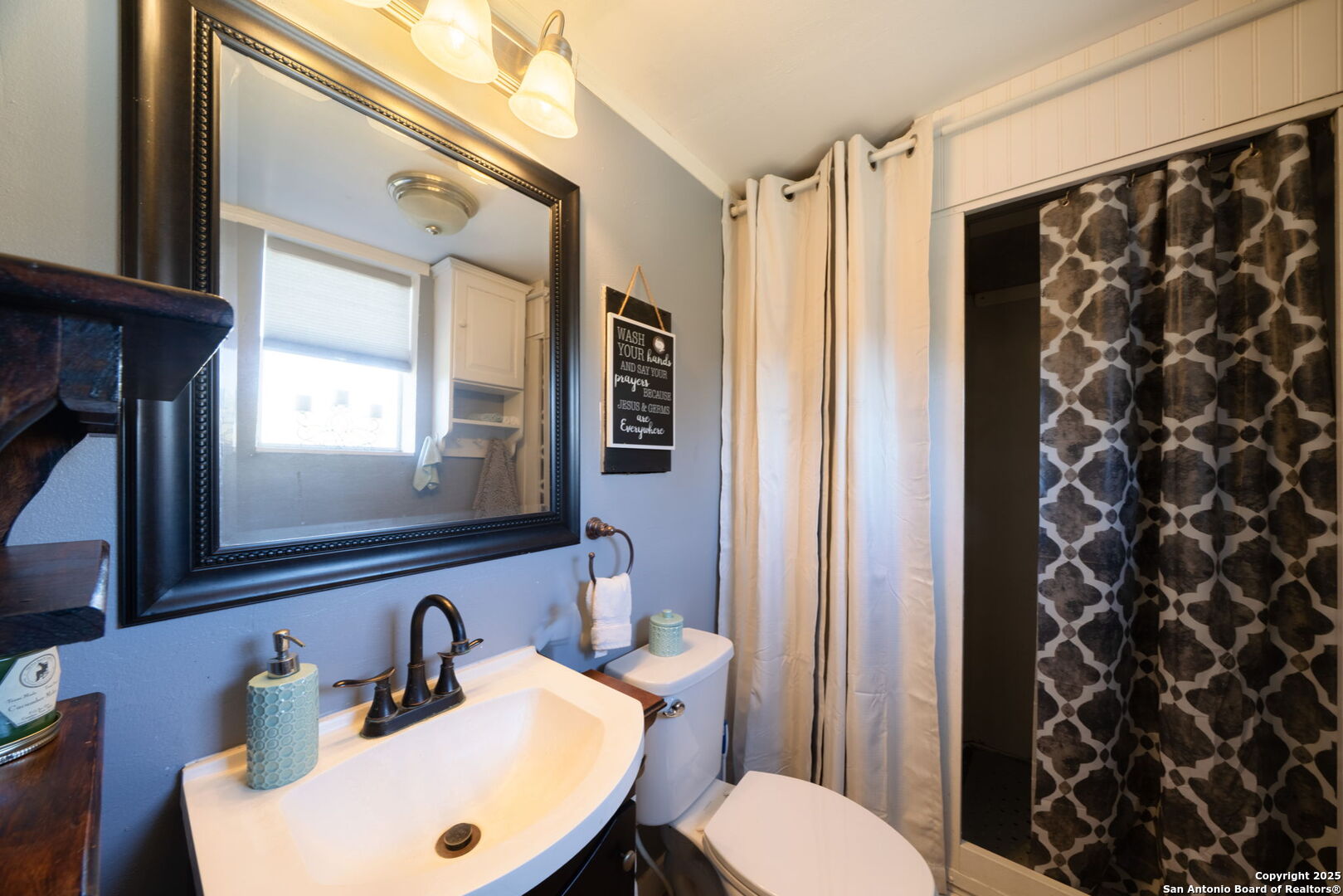 119 Post Oak Road La Vernia, TX 78121 - Photo 25 of 38 a bathroom with a sink and a mirror