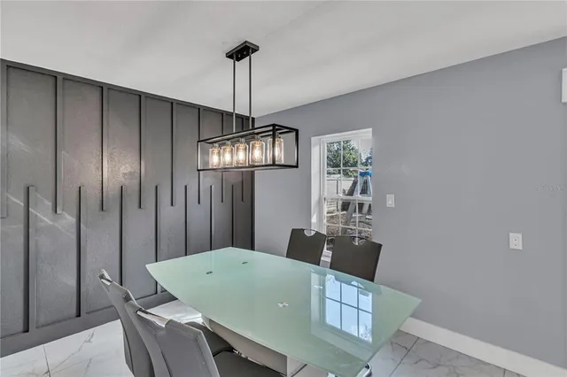 a dining room with a table and chairs