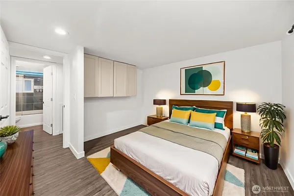 a bedroom with a bed and a flat screen tv