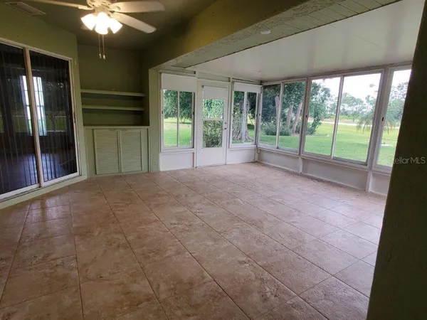 a view of an empty room with a fireplace and a large window