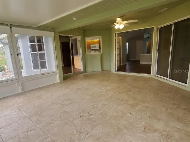 a view of an empty room with entrance and door