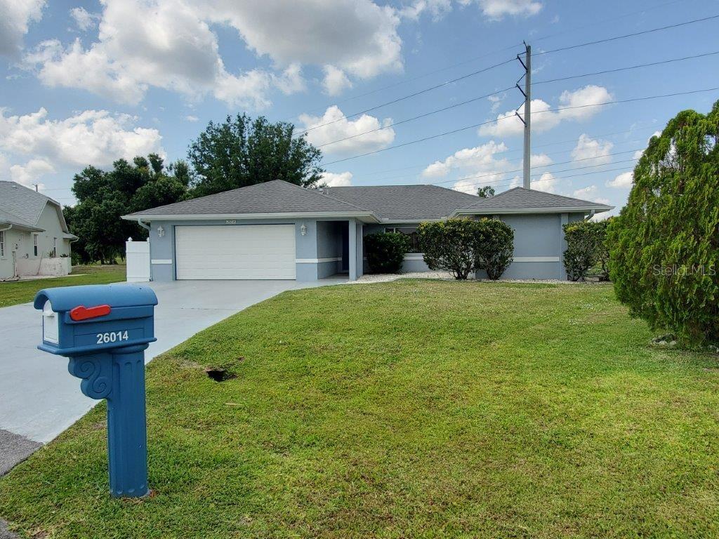26014 Ocelot Lane Punta Gorda, FL 33983 - Photo 2 of 35 a front view of a house with garden