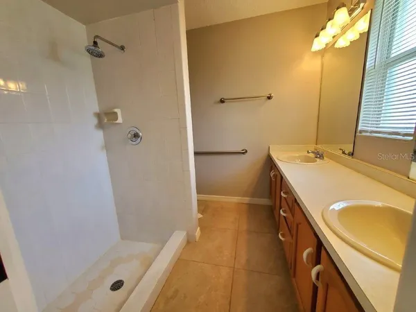 a bathroom with a tub a sink a vanity and a shower