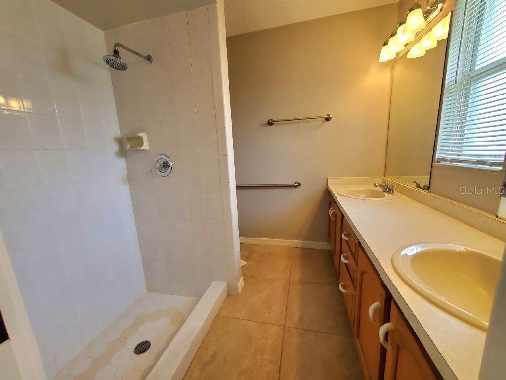26014 Ocelot Lane Punta Gorda, FL 33983 - Photo 24 of 35 a bathroom with a tub a sink a vanity and a shower