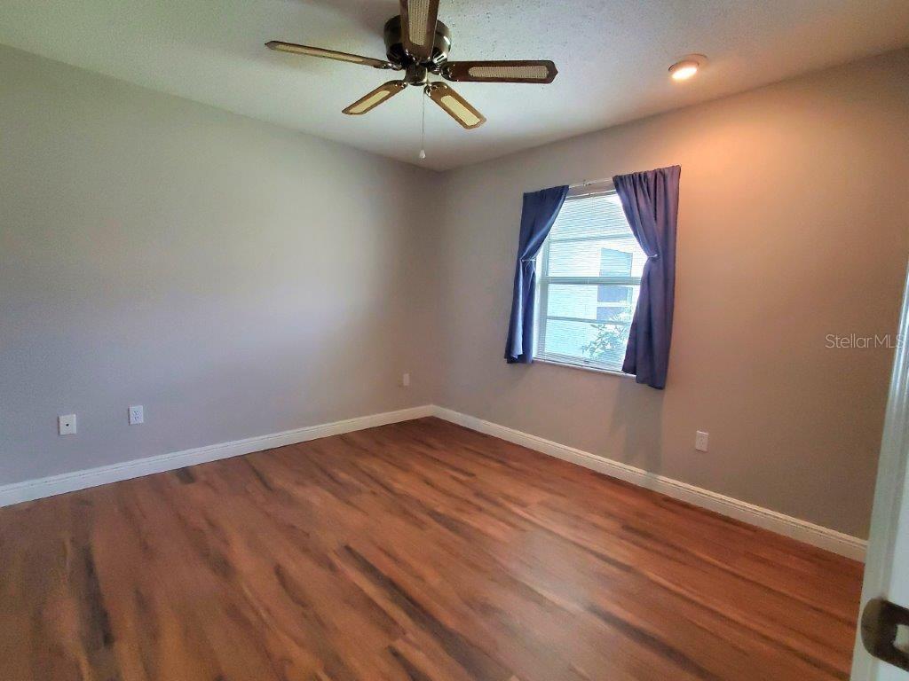 26014 Ocelot Lane Punta Gorda, FL 33983 - Photo 28 of 35 an empty room with windows and fan
