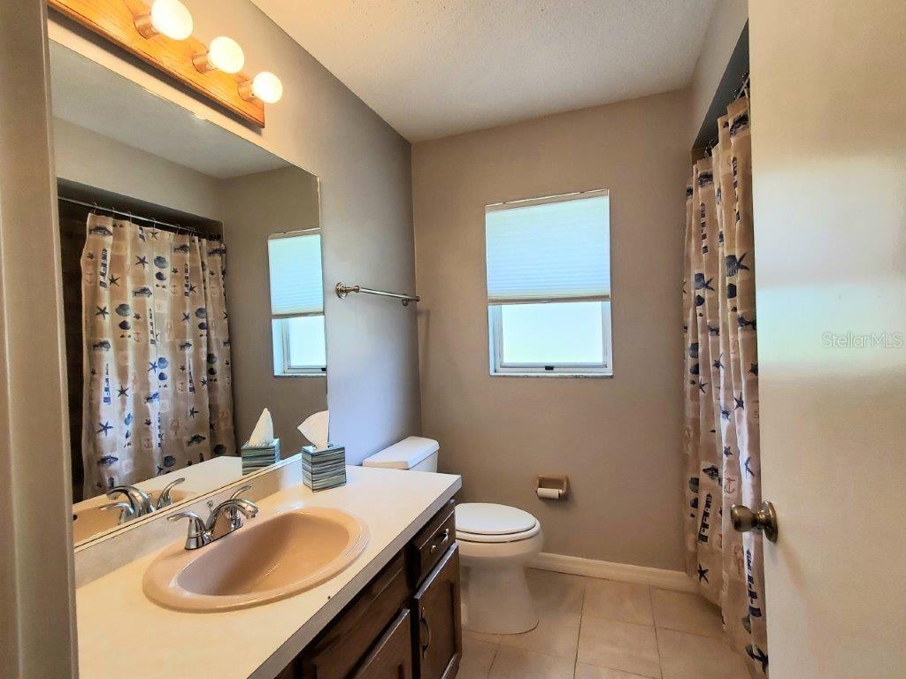 26014 Ocelot Lane Punta Gorda, FL 33983 - Photo 29 of 35 a bathroom with a sink toilet and shower