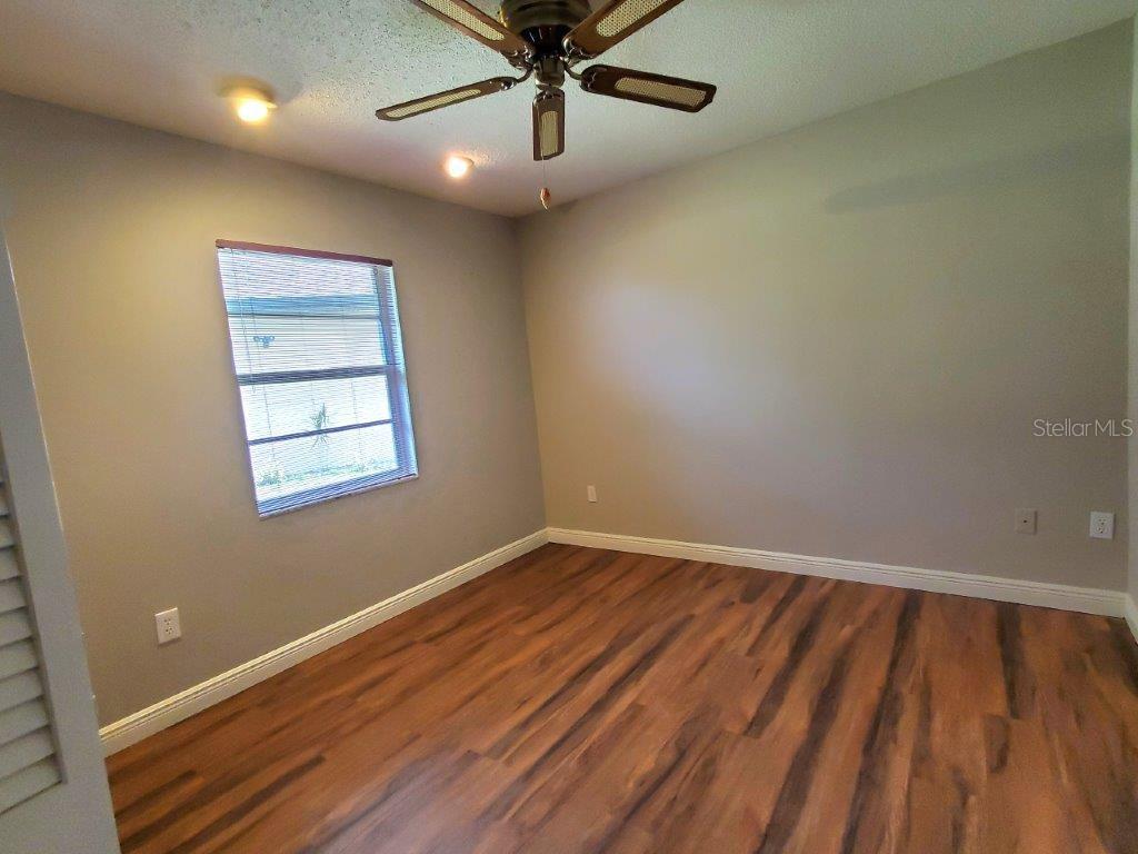 26014 Ocelot Lane Punta Gorda, FL 33983 - Photo 30 of 35 wooden floor in an empty room with a window