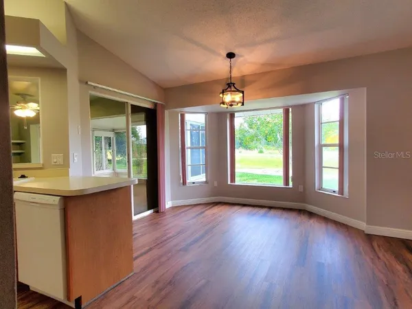 a view of livingroom with kitchen and hardwood