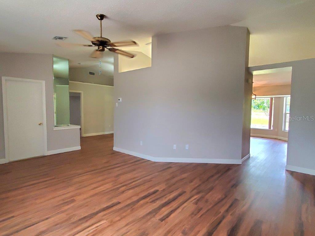26014 Ocelot Lane Punta Gorda, FL 33983 - Photo 9 of 35 a view of empty room with wooden floor and ceiling fan