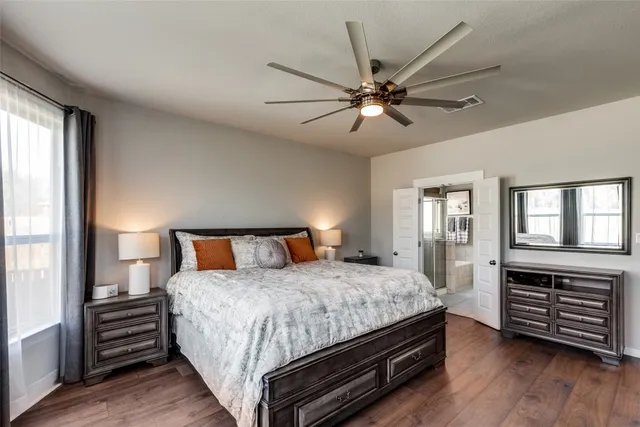 a bedroom with a bed and wooden floor